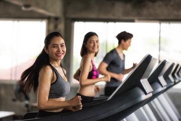 Fototapeta na wymiar Asian friends run on machine at gym