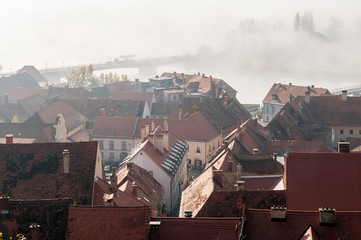 Beautiful aerial view of the historic center of Ptuj, Slovenia, wrapped in the morning fog