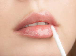  Woman Apply Moisturizing Lip Gloss - 283396422