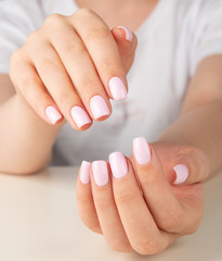 female hand with light pink nail design....