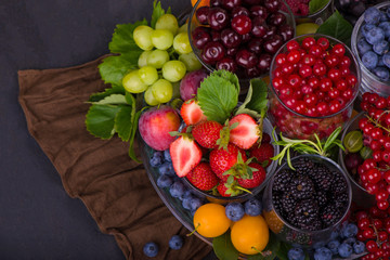 summer fresh berries of different types on a black background
