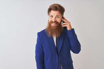 Young redhead irish businessman talking on the smartphone over isolated white background with a happy face standing and smiling with a confident smile showing teeth