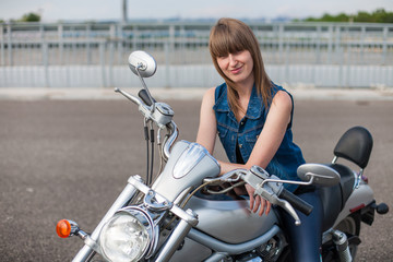 Plakat sexy biker woman sitting on classic style cruiser motorbike Girl biker with perfect fit slim body. The spirit of freedom and independence. Beautiful brave woman is leaning on her motorcycle on highway