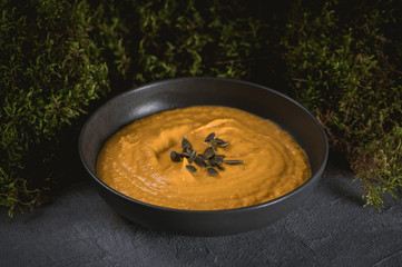 Pumpkin cream soup with cream and pumpkin seeds