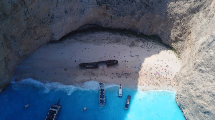 Aerial drone panoramic breathtaking view of iconic beach of Navagio or Shipwreck with deep turquoise clear sea and beautiful clouds, Zakynthos island, Ionian, Greece