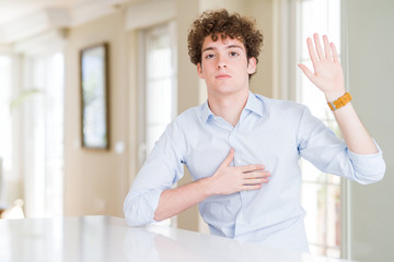 Young business man with curly read head Swearing with hand on chest and open palm, making a loyalty...