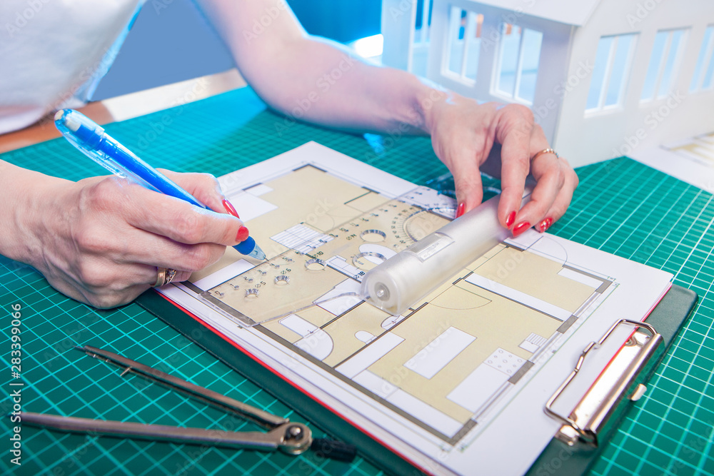 Poster the designer develops the floor plan of the building. draftsman holding a ruler and pencil. architec