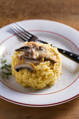 Healthy vegetarian dish: couscous with creamy mushroom sauce. Couscous with topping