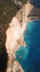 Aerial drone view of iconic beach of Navagio or Shipwreck voted one of the most beautiful beaches in the world with deep turquoise clear sea, Zakynthos island, Ionian, Greece