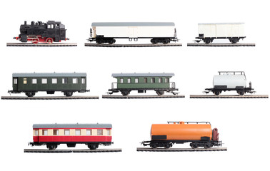 Model of a steam locomotive and cistern on rails on a white background