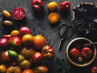 Composition with delicious tomatoes, wooden board and products on grey background, healthy food, vegetables