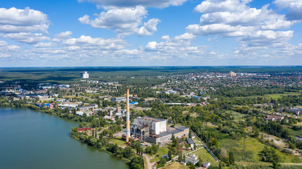 Fototapeta na wymiar Aerial panoramic view of Factory or Plant Industrial Area with many pipes or chimneys with smoke. Heavy industry of Metallurgical Production industry landscape from drone