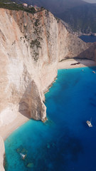 Aerial drone view of iconic beach of Navagio or Shipwreck voted one of the most beautiful beaches in the world with deep turquoise clear sea, Zakynthos island, Ionian, Greece