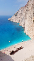 Aerial drone view of iconic beach of Navagio or Shipwreck voted one of the most beautiful beaches in the world with deep turquoise clear sea, Zakynthos island, Ionian, Greece