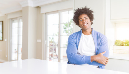 African American man at home happy face smiling with crossed arms looking at the camera. Positive person.
