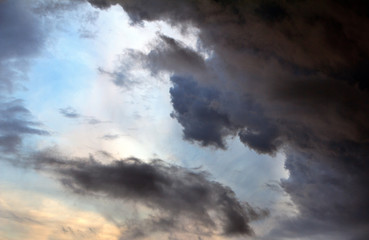 Storm clouds..Textural dark clouds against a blue sky.