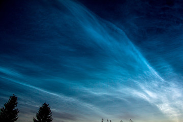 Beautiful night sky with stars and silvery clouds..Noctilucent clouds in the sky over Europe.