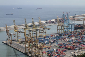 Harbour of Barcelona, Spain, with freight contenairs and Cranes. cranes - 283402438