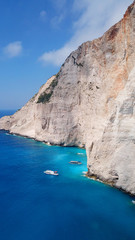 Fototapeta premium Aerial drone view of iconic beach of Navagio or Shipwreck voted one of the most beautiful beaches in the world with deep turquoise clear sea, Zakynthos island, Ionian, Greece