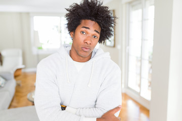 African American man wearing sweatshirt skeptic and nervous, disapproving expression on face with crossed arms. Negative person.