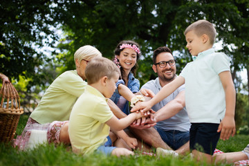 Naklejka na ściany i meble Family picnic outdoors togetherness relaxation happiness concept