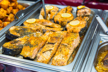 Fresh steamed fish steaks in metal tray