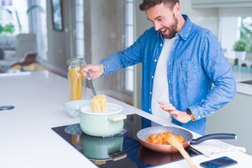 Handsome man cooking pasta at home