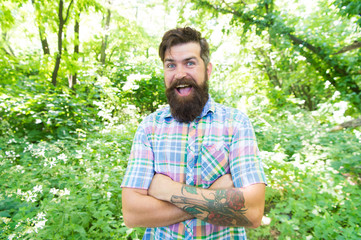 Naklejka na ściany i meble Im happy its my vacation. Cheerful caucasian guy going on vacation on natural landscape. Bearded man enjoying summer vacation. Hipster smiling during vacation time