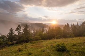 Amazing mountain landscape with colorful vivid sunset.