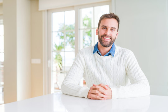 Handsome man wearing casual sweater with a happy and cool smile on face. Lucky person.