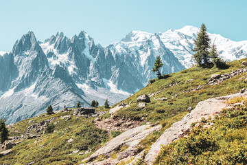 Fototapeta na wymiar Alpine landscape with snow capped mountains including the highest mountain of Europe Mount Blanc. Photographed in late summer near Chamonix, France. French Alps in summer. Adventure, mountain hiking
