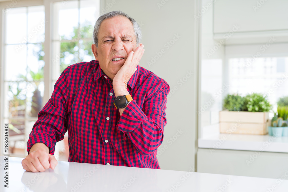 Wall mural Handsome senior man at home touching mouth with hand with painful expression because of toothache or dental illness on teeth. Dentist concept.