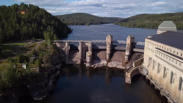 Aerial, drone shot, tilting towards the Solbersfossen hydro powerplant dam, at Glomma river, on a sunny day, in Spydeberg, Ostfold, Norway