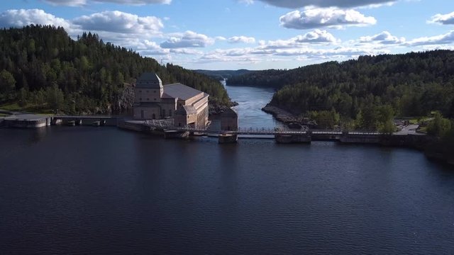 Aerial, drone shot, over the Solbersfossen hydro powerplant dam, at Glomma river, on a sunny day, in Spydeberg, Ostfold, Norway