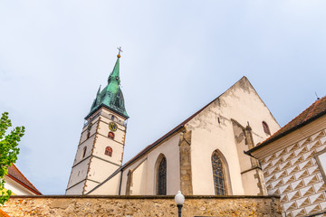 Fototapeta premium Spiky tower of Church of the Assumption of the Virgin Mary in Jindrichuv Hradec, Czech Republic