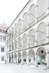 Fototapeta premium Great arcades - white renaissance archs on Third Courtyard of Jindrichuv Hradec Castle in Jindrichuv Hradec, Czech Republic