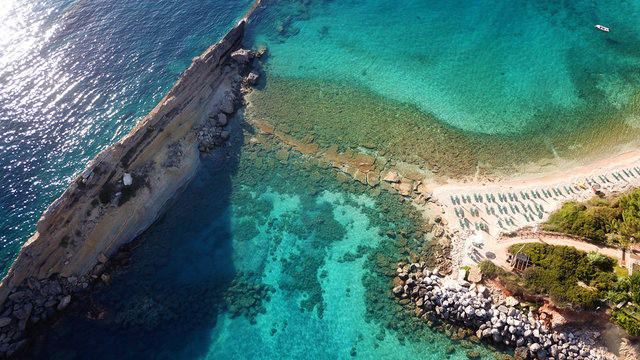 Aerial drone photo of iconic white rock cliffs and volcanic formations near famous beach of Platys and Makrys gialos with turquoise clear sea, Argostoli, Cefalonia island, Ionian, Greece