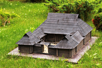 Fototapeta na wymiar Miniature old wooden building in the garden