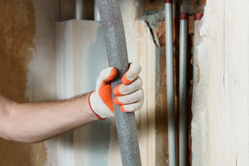 Hand with porous pipe insulation.