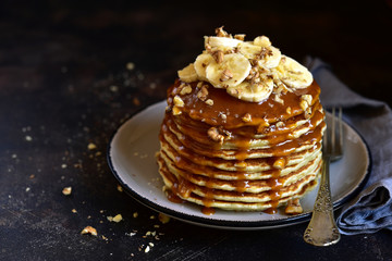 Homemade delicious banana pancakes with caramel sauce.