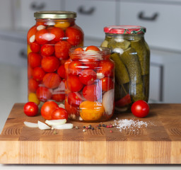 canned tomatoes and pickled cucumbers, homemade preserved vegetables