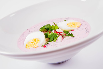 Cold borscht (chlodnik) - traditional Lithuanian cold soup with radish, parsley, dill and egg