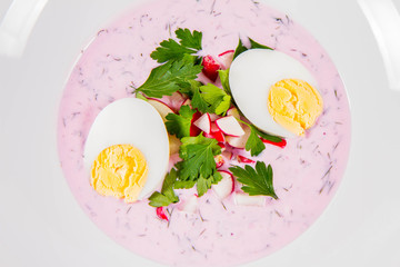 Cold borscht (chlodnik) - traditional Lithuanian cold soup with radish, parsley, dill and egg