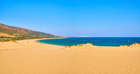 Fototapeta na wymiar Punta Paloma beach, a unspoiled white sand beach of The Nature Park del Estrecho. View from the Dune of Valdevaqueros. Valdevaqueros inlet. Tarifa, Cadiz. Andalusia, Spain.