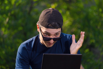 A scam victim checks his electronic wallet, not believing his eyes. Internet theft concept