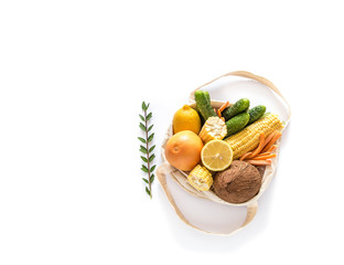 Grocery shopping with eco bag over white background. Zero waste and plastic free concept. Flat lay. Copy space.