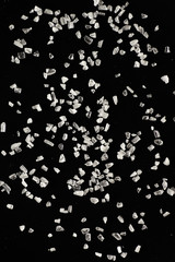 White salt on a black background.