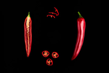 Seamless pattern with red hot chili peppers. Vegetables abstract background. Food collage, slicing hot red chili peppers Red hot chili peppers on a black background.