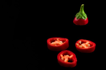 Seamless pattern with red hot chili peppers. Vegetables abstract background. Food collage, slicing hot red chili peppers Red hot chili peppers on a black background.