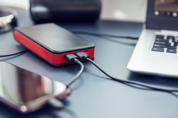 Close up to power bank USB-C ports connected to two devices.